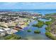 Stunning aerial view of waterfront community with lush landscaping and boat access to the beautiful open bay waters at 2117 Michigan Ave, Englewood, FL 34224