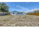 Expansive backyard featuring a wooden fence, offering privacy and ample space for outdoor activities and future landscaping at 2117 Michigan Ave, Englewood, FL 34224