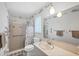 Bright bathroom with a shower/tub combo, toilet and large mirror over a single sink vanity at 2117 Michigan Ave, Englewood, FL 34224