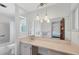 Clean bathroom with a long vanity sink, modern fixtures, and combined tub/shower at 2117 Michigan Ave, Englewood, FL 34224