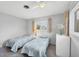 Bright bedroom featuring twin beds, natural light, and a chest of drawers for storage at 2117 Michigan Ave, Englewood, FL 34224
