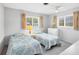 Cozy bedroom with twin beds, natural light, and a chest of drawers for storage at 2117 Michigan Ave, Englewood, FL 34224