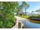 Concrete boat ramp leading into the water with some greenery nearby on a sunny day at 2117 Michigan Ave, Englewood, FL 34224