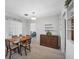 Neutral dining area featuring a ceiling fan, stylish shelving, and easy access to adjoining living spaces at 2117 Michigan Ave, Englewood, FL 34224