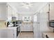 Bright kitchen with white cabinetry, updated appliances, and an efficient layout at 2117 Michigan Ave, Englewood, FL 34224