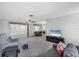 Open living room with carpet and large windows next to a dining area at 2117 Michigan Ave, Englewood, FL 34224