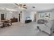 Bright living room featuring a ceiling fan, comfortable seating, and a view of the front yard at 2117 Michigan Ave, Englewood, FL 34224