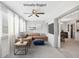 Bright living room with natural light, a brown sectional couch, and seamless access to the dining area through sliding doors at 2117 Michigan Ave, Englewood, FL 34224