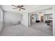 Bright living room featuring a ceiling fan and seamless access to the adjacent living area through wide sliding doors at 2117 Michigan Ave, Englewood, FL 34224