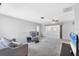 Spacious living room with neutral carpet, lots of light, and comfortable seating at 2117 Michigan Ave, Englewood, FL 34224