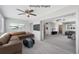 Staged living room features a comfortable sectional couch, ceiling fan and an inviting atmosphere at 2117 Michigan Ave, Englewood, FL 34224
