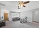 Neutral living room features a ceiling fan, and lots of light from a front window at 2117 Michigan Ave, Englewood, FL 34224