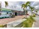 Charming shops with brick-paved walkways and palm trees create a quaint and inviting atmosphere at 2117 Michigan Ave, Englewood, FL 34224