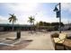 Street view featuring vibrant storefronts, palm trees, and a shaded bench on a sunny day at 2117 Michigan Ave, Englewood, FL 34224