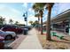Sidewalk street view showing shops, palm trees, and parked cars at 2117 Michigan Ave, Englewood, FL 34224