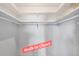 Empty walk-in closet with installed shelving and hanging rods for storage at 2117 Michigan Ave, Englewood, FL 34224