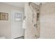 Beautifully tiled walk-in shower in neutral tones features dual shower heads and a convenient recessed niche at 2441 Vance Ter, Port Charlotte, FL 33981