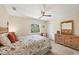 Comfortable bedroom with floral bedding, a rattan dresser, and a window with a view of the outdoors at 2441 Vance Ter, Port Charlotte, FL 33981