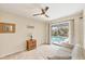 Bright bedroom overlooking the pool features a ceiling fan, neutral decor, and sliding glass door access at 2441 Vance Ter, Port Charlotte, FL 33981