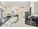 Modern kitchen with white cabinets, granite counters, and stainless steel appliances at 2441 Vance Ter, Port Charlotte, FL 33981