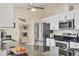 This kitchen is fitted with granite counters, stainless appliances, and ample cabinet space at 2441 Vance Ter, Port Charlotte, FL 33981