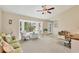 Bright open living room with vaulted ceiling, fan, and large windows with a view at 2441 Vance Ter, Port Charlotte, FL 33981