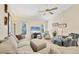 Bright living room with comfortable seating, ceiling fan, and a flat screen TV with a view of the beach at 2441 Vance Ter, Port Charlotte, FL 33981