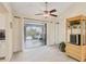 An inviting living room features a ceiling fan, large glass sliding doors, and stylish decor at 2441 Vance Ter, Port Charlotte, FL 33981