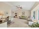 Bright living room with vaulted ceiling, ceiling fan, and desk area for a flexible space at 2441 Vance Ter, Port Charlotte, FL 33981