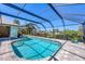 Relax and unwind in this screened-in pool area with ample space for lounging and enjoying the outdoors at 2441 Vance Ter, Port Charlotte, FL 33981