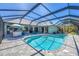 Enjoy this large in-ground pool surrounded by lush landscaping and a screened enclosure in this backyard oasis at 2441 Vance Ter, Port Charlotte, FL 33981