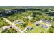 Aerial view showcases a neighborhood home surrounded by lush greenery and mature trees at 2678 Alva St, North Port, FL 34291