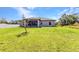Well-manicured lawn extends from the rear of this single-story house, creating a picturesque and inviting outdoor space at 2678 Alva St, North Port, FL 34291