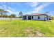Expansive backyard featuring a well-maintained lawn and partial fencing offers plenty of room to enjoy outdoor activities at 2678 Alva St, North Port, FL 34291
