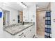 Bathroom featuring granite countertop, walk-in shower, and tile floors at 2678 Alva St, North Port, FL 34291