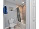 Bathroom featuring modern bathtub with neutral-colored tiled shower at 2678 Alva St, North Port, FL 34291