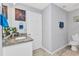 Bathroom featuring granite countertop, white cabinets, and modern faucet at 2678 Alva St, North Port, FL 34291