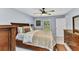 Bright bedroom featuring a ceiling fan, wood furniture, and a window with natural light at 2678 Alva St, North Port, FL 34291