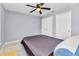 Bedroom features neutral walls, tile floor, ceiling fan and two double door closets at 2678 Alva St, North Port, FL 34291