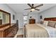 Bedroom featuring tile floors, a ceiling fan, and an ensuite bathroom at 2678 Alva St, North Port, FL 34291