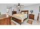 Well-lit bedroom with tile floors, ceiling fan, and wood furnishings at 2678 Alva St, North Port, FL 34291