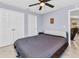 Bedroom features neutral walls, tile floor, ceiling fan, two double door closets and access to living space at 2678 Alva St, North Port, FL 34291