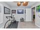 Exercise room with cycling bike, medal display, and access to the living room at 2678 Alva St, North Port, FL 34291