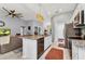 Open kitchen with island sink, stainless appliances, and seamless flow into the living room, great for entertaining at 2678 Alva St, North Port, FL 34291
