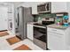 Well-equipped kitchen with stainless steel appliances, granite countertops, tile backsplash, and plenty of cabinet space at 2678 Alva St, North Port, FL 34291