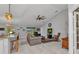 This living room has a ceiling fan, tile flooring, and natural light that filters through the sliding glass doors at 2678 Alva St, North Port, FL 34291