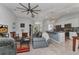 Spacious living room with comfortable seating, a ceiling fan, and views into the kitchen and other living spaces at 2678 Alva St, North Port, FL 34291