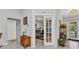 Hallway view of office with glass paneled door, natural light, and open access at 2678 Alva St, North Port, FL 34291