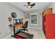 Bright office featuring a treadmill, computer, window, and a red shelving unit at 2678 Alva St, North Port, FL 34291