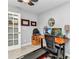 Home office with computer, treadmill, and natural light at 2678 Alva St, North Port, FL 34291
